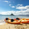 Tandem or Single kayak rental at Kualoa Regional Park, kayaks on the beach.