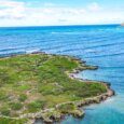 An arial photo of Popoia Island with the Mokulua Islands in the background