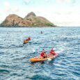 Paddlers on a kayak tour returning to shore on an afternoon tour of the Mokulua Islands