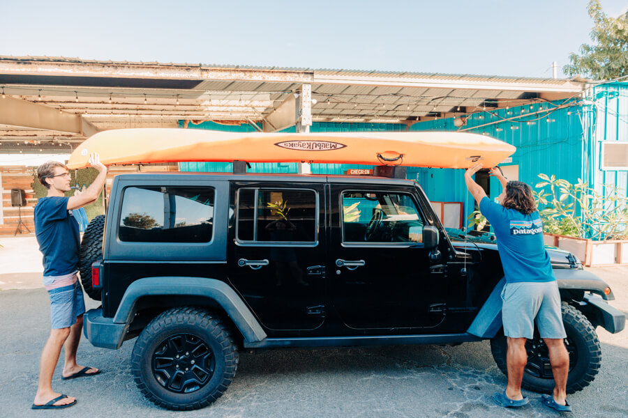 Active Oahu staff place the kayak on top of the vehicle