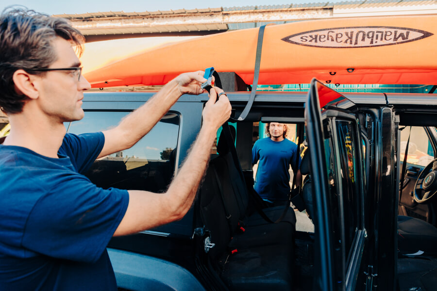 Active Oahu staff threads the strap through the buckle