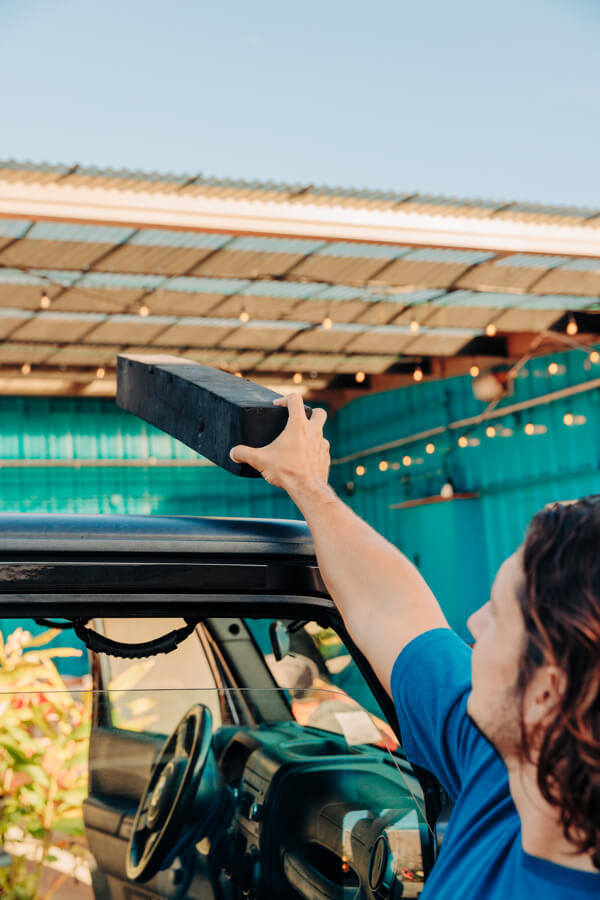 Active Oahu Staff placing foam pads on top of a vehicle