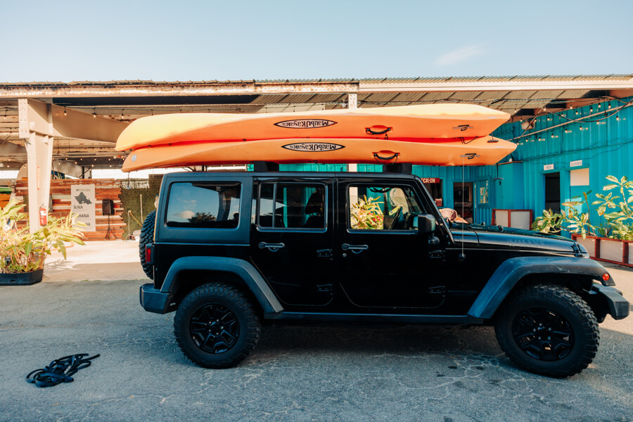 A vehicle with two kayaks stacked on top