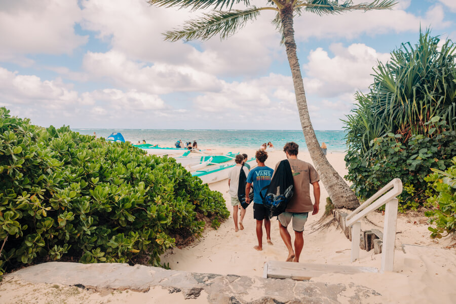 people walking on the sand to Lanikai beach with their snorkel gear rentals from Active Oahu