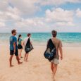 people walking toward the ocean with their snorkel gear rentals in Kailua