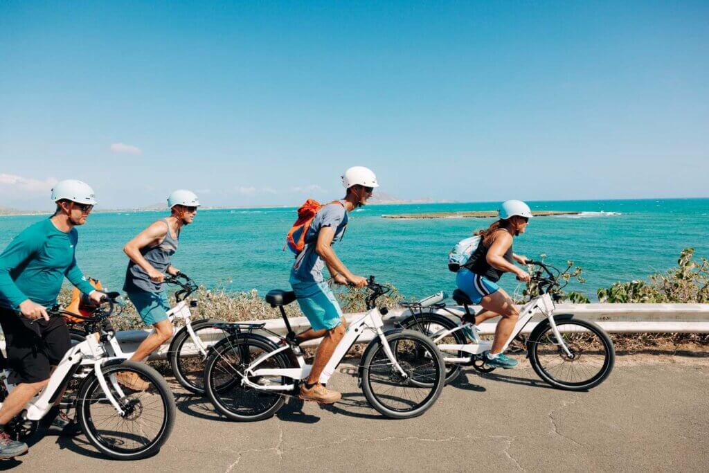 guests e-biking to a scenic lookout in Kailua overlooking the ocean