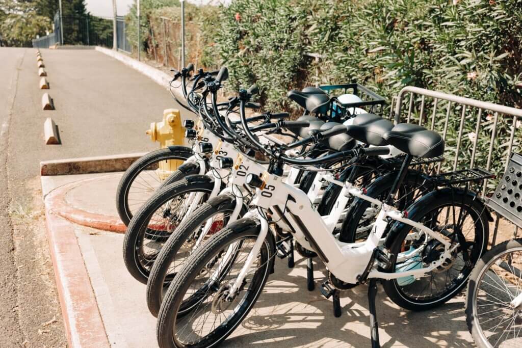 E-bike rentals from Active Oahu locked to a bike rack outside.
