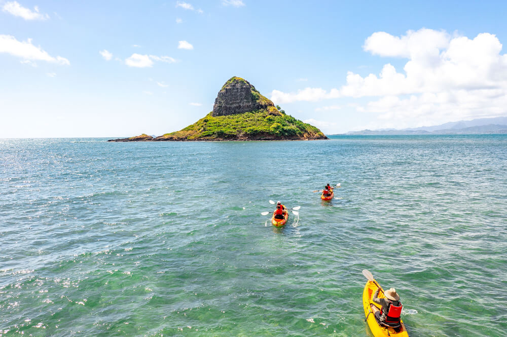people paddle towards Chinaman's hat with their kayak rentals from Active Oahu