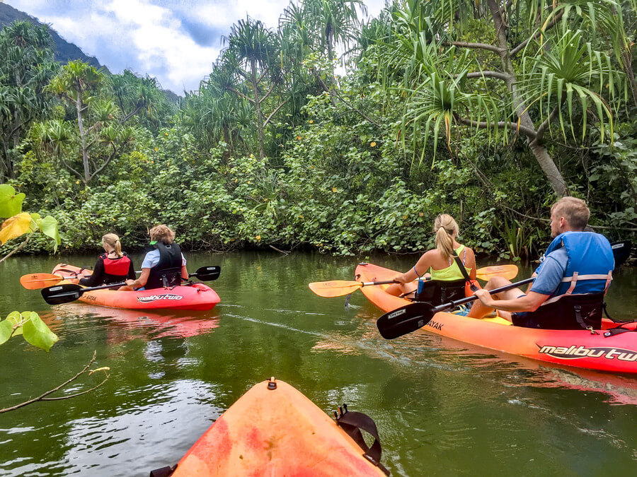 People on kayak rentals from Active Oahu paddling in Kahana River