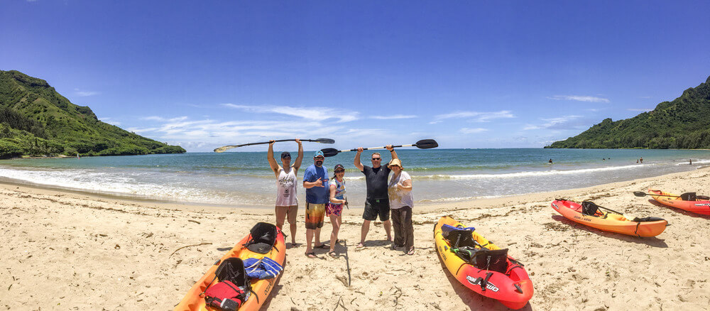 Visitors landed on Kahana Bay beach with their kayak rentals from Active Oahu