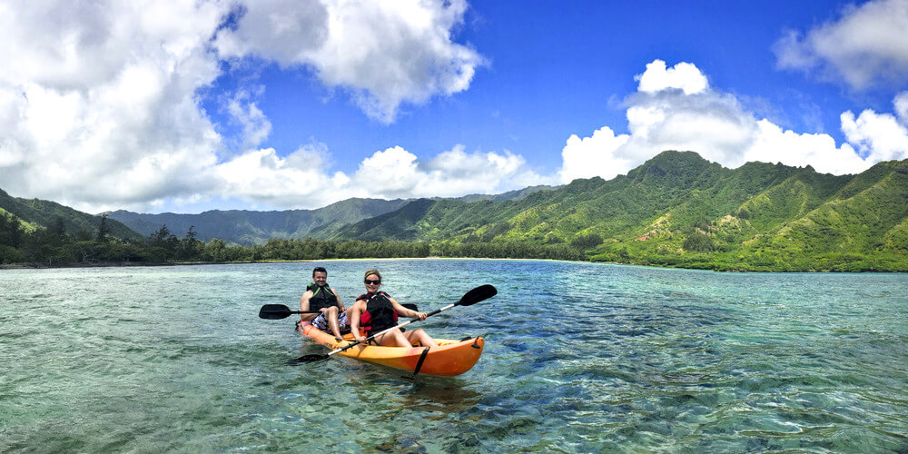 Two people on a tandem kayak rental from Active Oahu in Kahana Bay