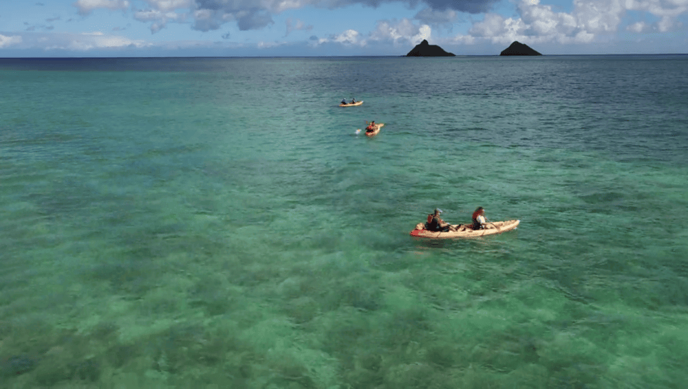 three tandem kayak rentals from Active Oahu with the Mokulua Islands in the distance