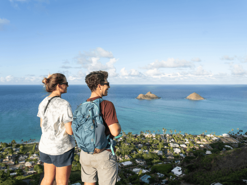 Two people looking at the view of the ocean from the Lanikai Pillbox