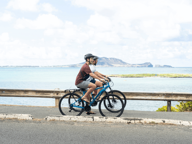 Two people e-biking to the Lanikai Pillbox hike