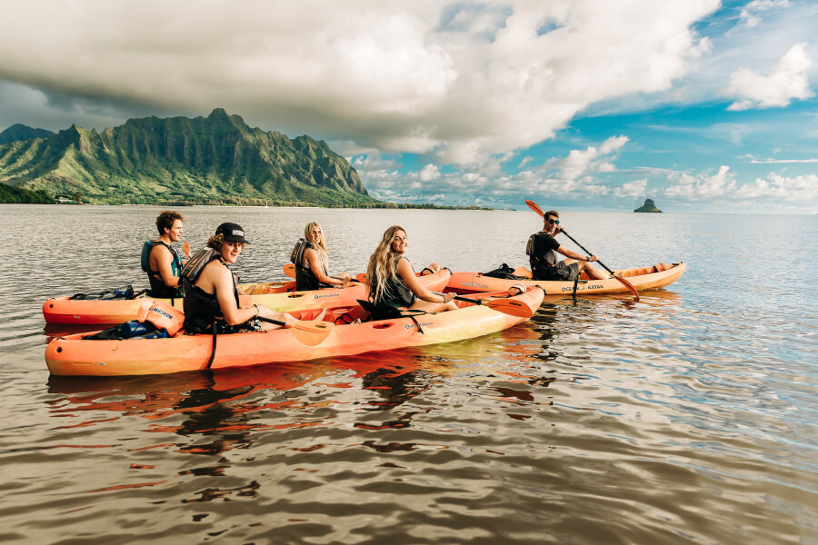 A group of people kayaking to the Kaneohe Sandbar with their rentals from Active Oahu
