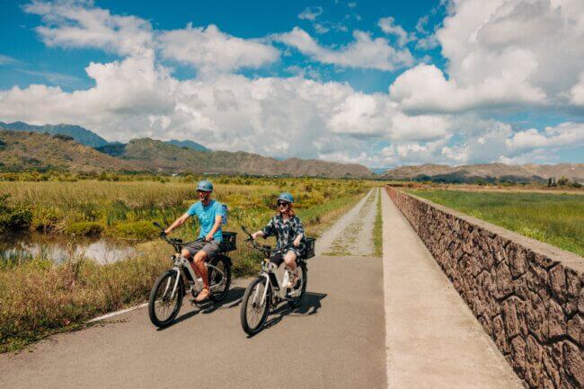 Two people e-bike on the Kailua Marsh Trail