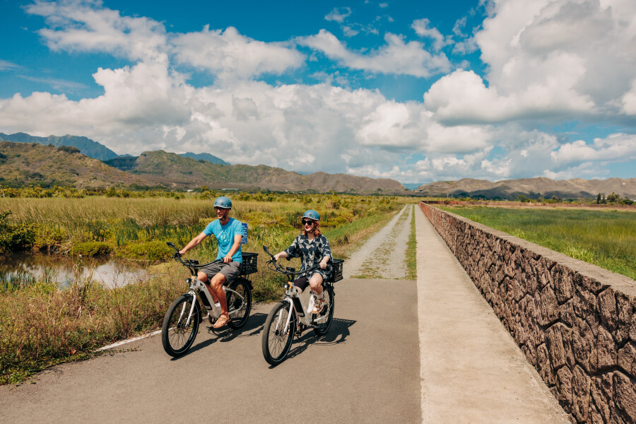 Two people e-bike on the Kailua Marsh Trail